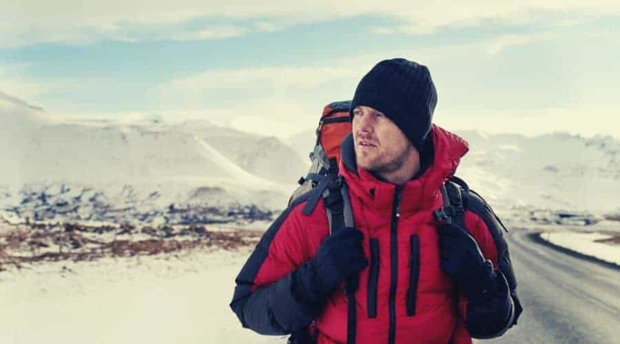 backpacker wearing 3 layered clothing system intext