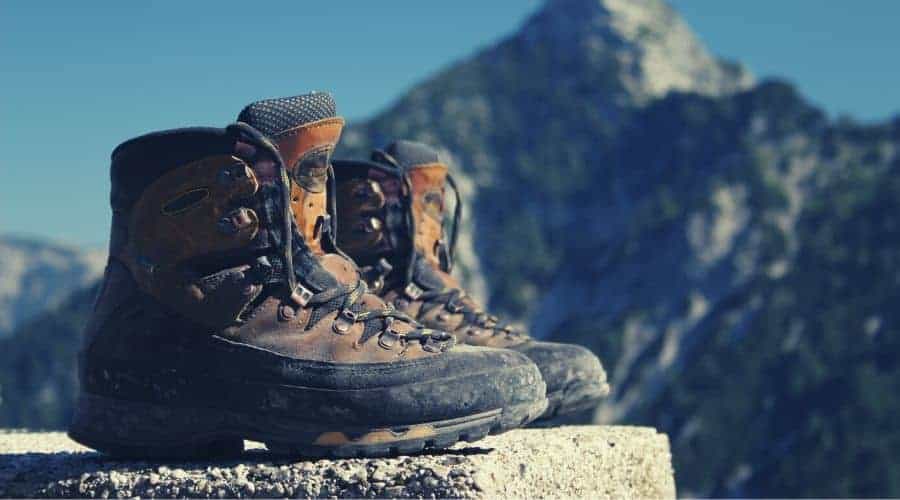 pair of hiking boots sitting on rock