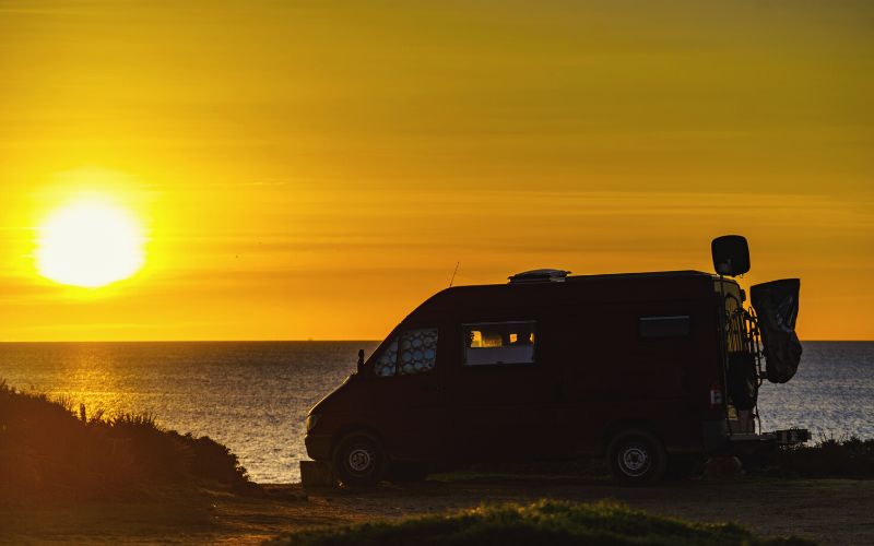 Camper van at beach at sunrise