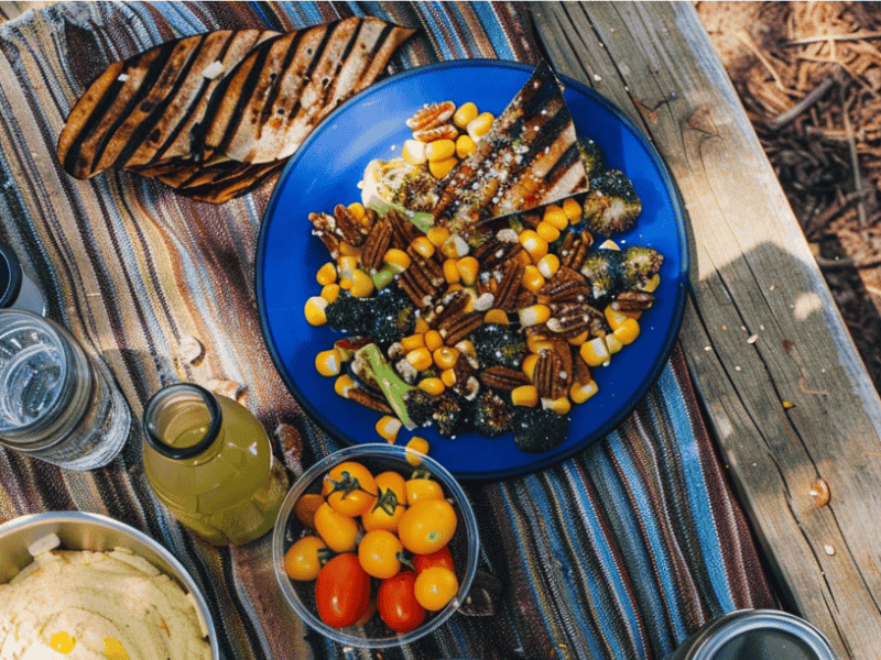 selection of healthy camping meals sitting on a camping table